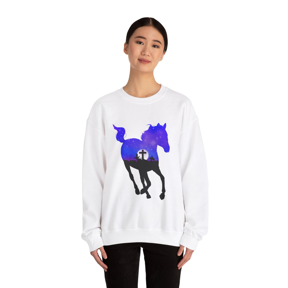 
                  
                    Load image into Gallery viewer, Mockup of a person wearing a white crewneck sweater featuring a silhouette of a horse with the image of a purple and blue starry night inside of the silhouette, a full moon on the horizon, and a silhouette of a cross against the moon.
                  
                