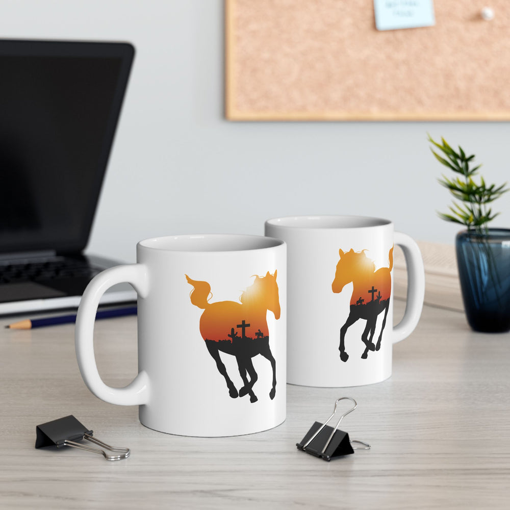 
                  
                    Load image into Gallery viewer, Mockup of a coffee mug featuring the silhouette of a running horse with an orange sky and crow outline in it
                  
                